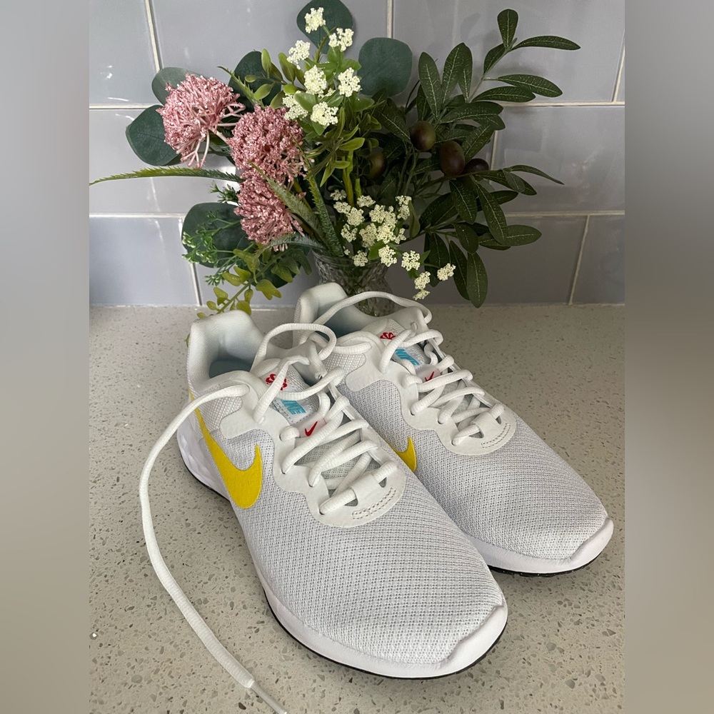 Brand new, never worn, size 6 white Nike with yellow swoosh